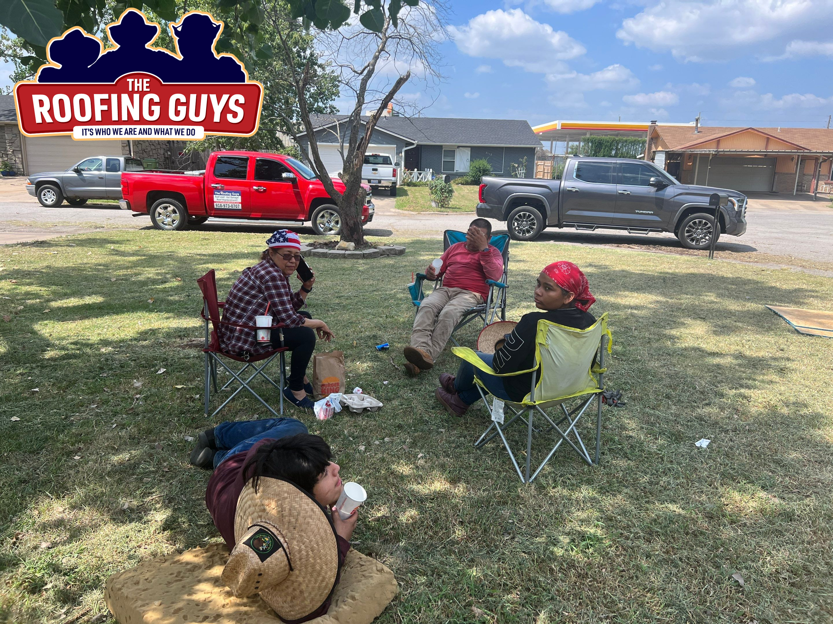 Roof crew taking lunch break in shade from a tree